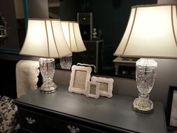 white lamps on the fireplace near the mirror