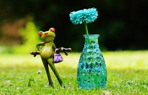 ceramic frog and flower in a bottle