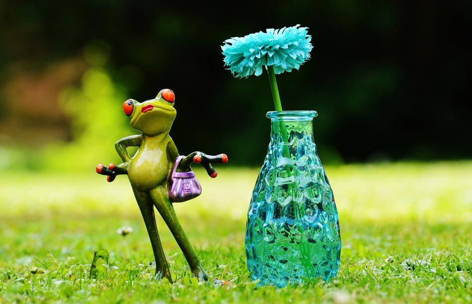 ceramic frog and flower in a bottle
