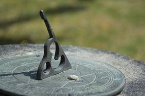 stone sundial on a stump