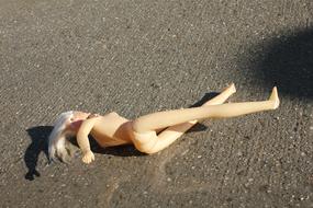 lying doll on the street