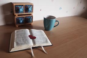 book on the table with a mug