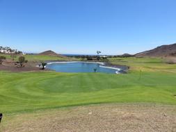 large golf course with a lake