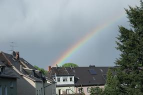 bright rainbow in the sky above the houses