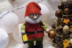 cute gnome in his clothes under the tree