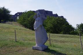 stone sculpture of a girl in a field