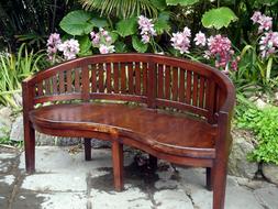 wooden bench in the garden near flowers
