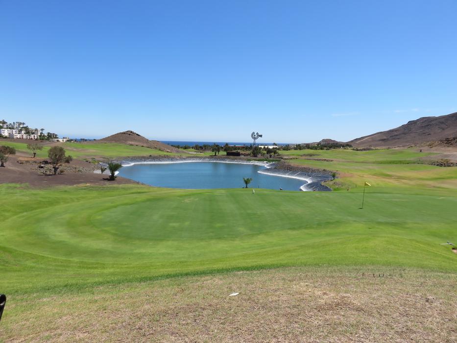 large golf course with a lake