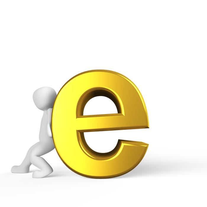 man holds up the letter e