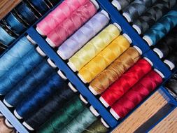colored threads in a sewing box