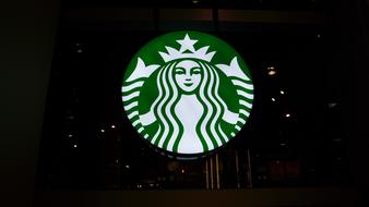 glowing starbucks sign in the night