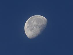 lonely moon in a blue sky