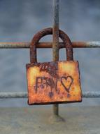 rusty lock on the fence with a heart