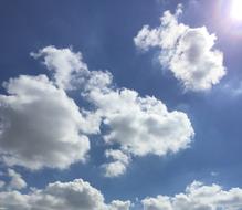 white beautiful clouds in the sky with the sun
