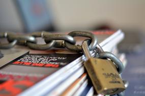 An iron lock on colorful books