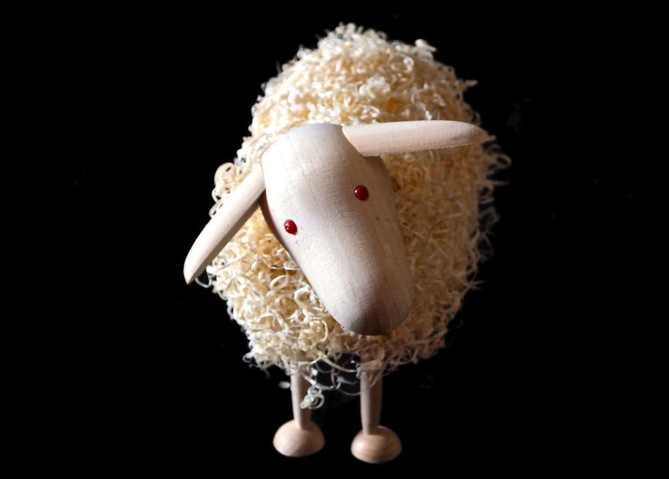 Cute and beautiful recycled figure of a sheep, at black background