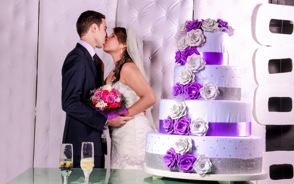 wedding cake with the couple in the background