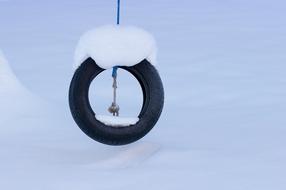 old Auto Tire Swing covered with snow