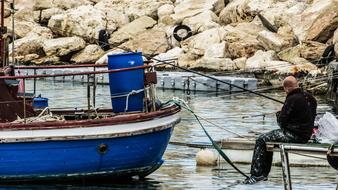 fisherman at sea by the boat