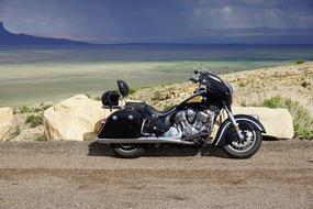 black luxury indian motorcycle parked in wilderness