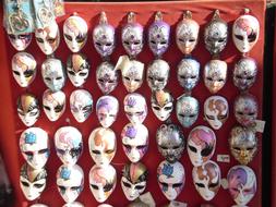 bright painted Carnival masks on stall, italy, venice