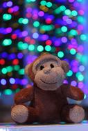 soft toy monkeys on the background of garlands
