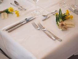 Cutlery and flowers on table served for wedding party