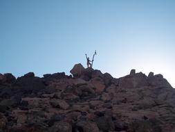 happy man with a flag on a rock
