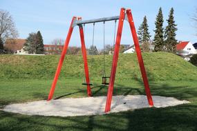 red swing in the park