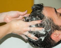 man gets his hair washed