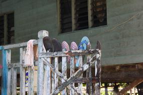 shoes on a wooden fence