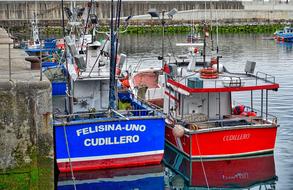 Colorful boats by the bridge
