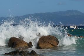 the splash of the wave against the rocks