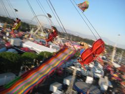 people on the merry blur ride