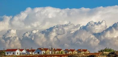 white clouds over the sky of the village