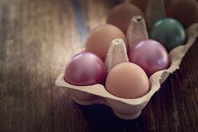 colored eggs in a cardboard box