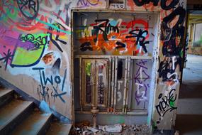 Inside view of the old, abandoned factory with colorful graffities