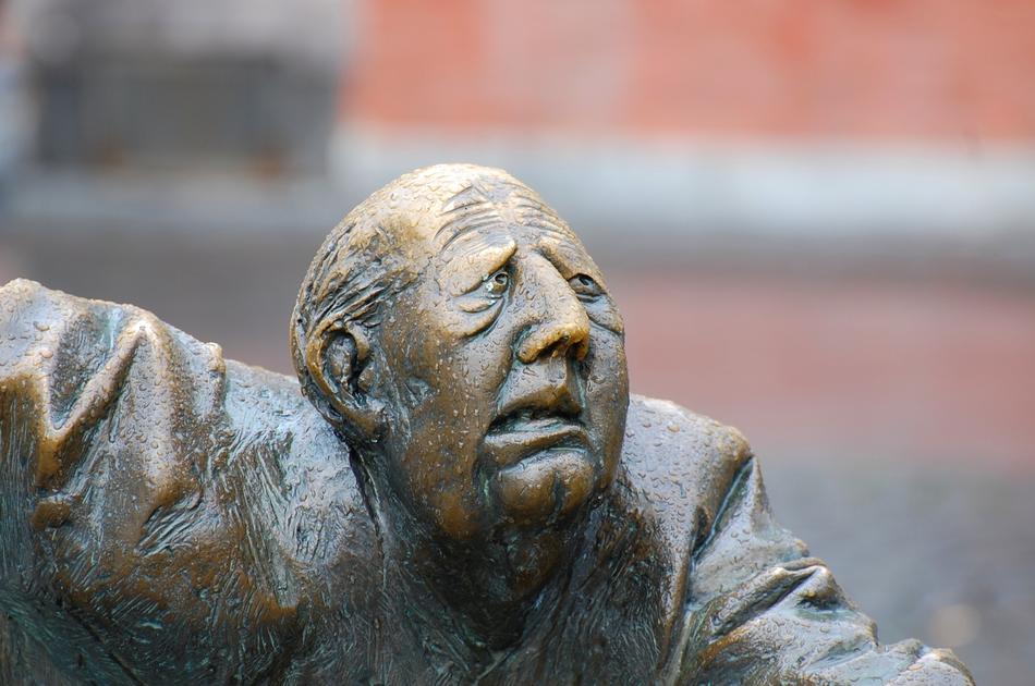 disgruntled face of the bronze man sculpture
