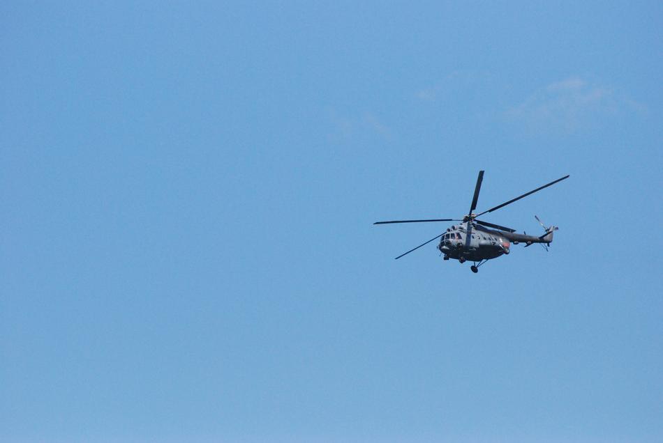 military helicopter in the blue sky
