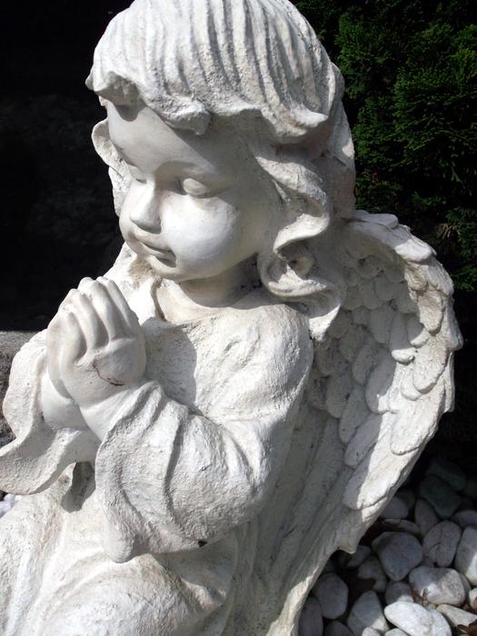 white stone sculpture of an angel