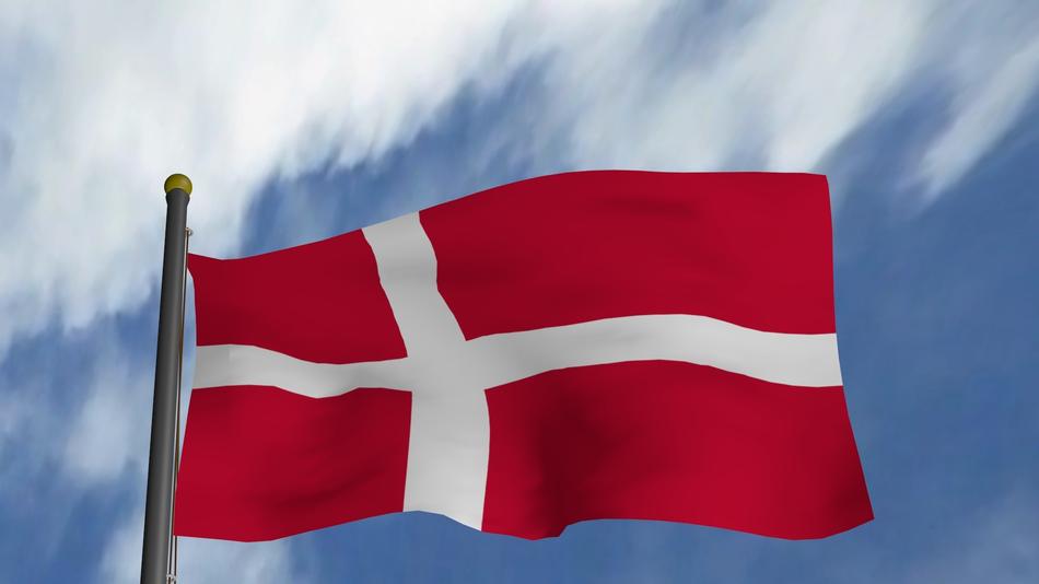The magnificent flag of Denmark against the blue sky