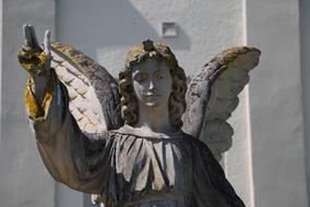 stone statue of an angel in the moss