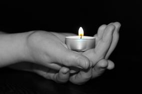 hands hold a candle
