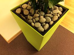stones decorating the yellow pot