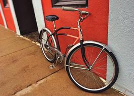 bicycle standing against the wall of a house