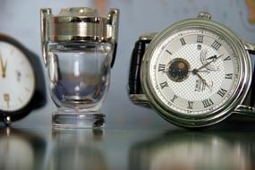 clock on the table with a glass