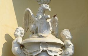 stone statues of eagles in front of the building