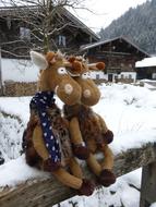 soft giraffes toys on the fence