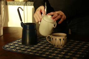 man pours tea