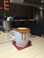 coffee flows out of the mug
